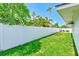 A large backyard with a white vinyl privacy fence at 9027 Merrimoor Blvd, Seminole, FL 33777