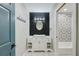 Stylish bathroom features an updated vanity, modern lighting, hexagon tile floor, and decorative tile shower at 9027 Merrimoor Blvd, Seminole, FL 33777
