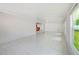 Large flex room with tile floors, an open layout, and ample natural light, great for entertaining at 9027 Merrimoor Blvd, Seminole, FL 33777