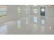 Bonus room with tile floors, multiple windows and natural light; ideal for a home office or playroom at 9027 Merrimoor Blvd, Seminole, FL 33777