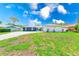 Charming home with a well-manicured front yard and a spacious driveway, perfect for Gathering living at 9027 Merrimoor Blvd, Seminole, FL 33777