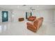 Bright and open living room with tile floors and comfortable seating, creating a relaxing atmosphere at 9027 Merrimoor Blvd, Seminole, FL 33777