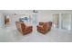 Open-concept living area with tile floors, seamlessly connecting the living room, dining, and kitchen spaces at 9027 Merrimoor Blvd, Seminole, FL 33777