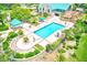 Aerial view of a refreshing community pool surrounded by lush landscaping at 9027 Merrimoor Blvd, Seminole, FL 33777