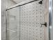 Updated shower with gray tiles and shower door at 9027 Merrimoor Blvd, Seminole, FL 33777