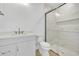 Modern bathroom featuring sleek vanity, toilet, and glass-enclosed shower with beautiful tile work and built-in shelving at 937 Old Welcome Rd, Lithia, FL 33547