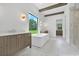 Bright bathroom featuring double vanities, a soaking tub, wood beam details, and a glass enclosed shower at 937 Old Welcome Rd, Lithia, FL 33547