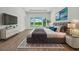 Spacious bedroom with hardwood floors, a large window, and a walk-in closet at 937 Old Welcome Rd, Lithia, FL 33547