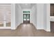 Bright and airy foyer with hardwood floors and double doors leading to the outside at 937 Old Welcome Rd, Lithia, FL 33547