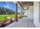 Covered front porch with wood columns, stone pavers, and meticulously maintained landscaping at 937 Old Welcome Rd, Lithia, FL 33547