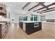 Island in modern kitchen with stainless steel appliances, white countertops, and wood ceiling beams at 937 Old Welcome Rd, Lithia, FL 33547