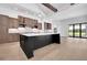 Kitchen with large island, stainless appliances, and seating area with a view of the outdoors at 937 Old Welcome Rd, Lithia, FL 33547