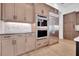 Kitchen features stainless steel appliances, built-in ovens, custom cabinetry, and sleek design at 937 Old Welcome Rd, Lithia, FL 33547