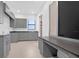 Laundry room with grey cabinets, countertop space, sink, and built-in desk at 937 Old Welcome Rd, Lithia, FL 33547