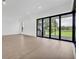 Bright, open living room with wood floors and sliding glass doors to the backyard at 937 Old Welcome Rd, Lithia, FL 33547
