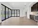Open living room with large sliding doors to the patio, a wet bar, and hardwood floors at 937 Old Welcome Rd, Lithia, FL 33547