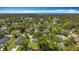 A wide aerial shows the property and homes among mature trees in neighborhood at 1011 Newton S Ave, St Petersburg, FL 33705