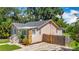 Home featuring stone accents, fenced backyard, and a well-maintained driveway at 1011 Newton S Ave, St Petersburg, FL 33705
