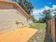 A view of the exterior elevation with small stairs leading to the grassy backyard and wood fence at 1011 Newton S Ave, St Petersburg, FL 33705