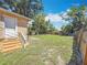 A spacious backyard features a wooden deck, a well-maintained lawn, and a sturdy wooden fence at 1011 Newton S Ave, St Petersburg, FL 33705
