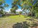 Expansive backyard enclosed by a wooden fence, offering ample green space and privacy at 1011 Newton S Ave, St Petersburg, FL 33705