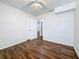 Bedroom featuring modern ceiling fan, wood floors, closet, and doorway to another room at 1011 Newton S Ave, St Petersburg, FL 33705