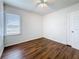 Cozy bedroom with wood-look floors and a ceiling fan, illuminated by natural light from the window at 1011 Newton S Ave, St Petersburg, FL 33705