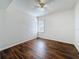 This bedroom features dark wood floors, textured walls, and a modern ceiling fan at 1011 Newton S Ave, St Petersburg, FL 33705