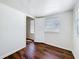 Bedroom featuring wood-look flooring and two windows for natural light at 1011 Newton S Ave, St Petersburg, FL 33705