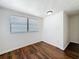 Bright bedroom featuring wood floors and a window with blinds at 1011 Newton S Ave, St Petersburg, FL 33705