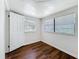 Bright bedroom with wood-look flooring and multiple windows providing plenty of natural light at 1011 Newton S Ave, St Petersburg, FL 33705