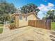Home exterior featuring stone accents, a fenced backyard, and a spacious driveway at 1011 Newton S Ave, St Petersburg, FL 33705
