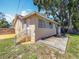 Rear exterior view of the home featuring a small deck, fenced yard, and stucco siding at 1011 Newton S Ave, St Petersburg, FL 33705
