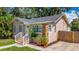 Charming house with stone detailing, a new roof, and a driveway leading to a wooden fence at 1011 Newton S Ave, St Petersburg, FL 33705