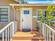 Inviting front entrance with a white door, small porch, and matching white railings at 1011 Newton S Ave, St Petersburg, FL 33705