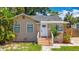 Charming single-story home featuring a beige stucco exterior and a well-manicured front yard at 1011 Newton S Ave, St Petersburg, FL 33705