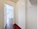 Hallway with hardwood flooring and doorway leading to room with natural light at 1011 Newton S Ave, St Petersburg, FL 33705