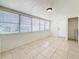 Living room featuring tile floors, neutral colored walls, and bright windows with white blinds at 1011 Newton S Ave, St Petersburg, FL 33705