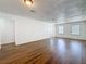Open-concept living room boasts wood-look flooring, and ample natural light at 1011 Newton S Ave, St Petersburg, FL 33705