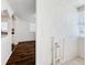 A view of the light-colored walls, dark hardwood floors, and doorway into the kitchen at 1011 Newton S Ave, St Petersburg, FL 33705