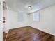 Living room with wood floors and a window, adjacent to the kitchen at 1011 Newton S Ave, St Petersburg, FL 33705