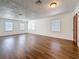 Spacious living room featuring wood-look flooring, natural light, and neutral paint at 1011 Newton S Ave, St Petersburg, FL 33705