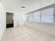 Bright living room with neutral tile floors, numerous windows, and in-wall plumbing at 1011 Newton S Ave, St Petersburg, FL 33705