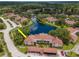 Scenic aerial view of charming condos surrounded by lush greenery and a beautiful lake at 10330 Carrollwood Ln # 95, Tampa, FL 33618