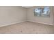 Empty bedroom with beige walls and carpet at 10330 Carrollwood Ln # 95, Tampa, FL 33618