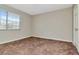 Empty bedroom with a carpeted floor and window at 10330 Carrollwood Ln # 95, Tampa, FL 33618
