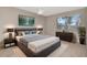 Comfortable bedroom featuring a ceiling fan, bedside lamps, a dresser, and a stylish decor at 10330 Carrollwood Ln # 95, Tampa, FL 33618