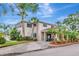 Exterior of a community clubhouse surrounded by lush landscaping and featuring a convenient golf cart at 10330 Carrollwood Ln # 95, Tampa, FL 33618