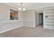 Dining room with carpeted floor, view to kitchen, and built-in bookshelf at 10330 Carrollwood Ln # 95, Tampa, FL 33618