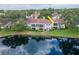 Waterfront condo featuring a screened porch, well-kept lawn, and vibrant landscaping near a tranquil pond at 10330 Carrollwood Ln # 95, Tampa, FL 33618